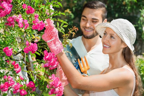 Gardener working in a suburban Pinner front garden