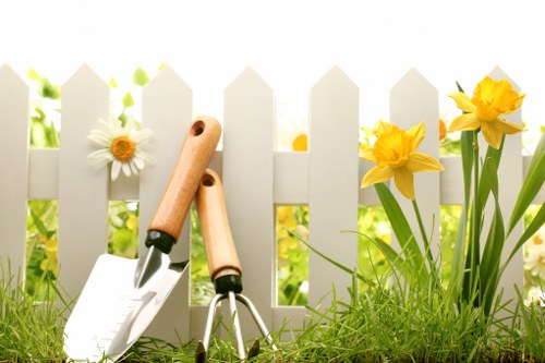 Photograph of a gardener's toolkit beside a hedge in Pinner