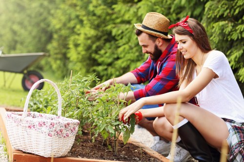 Gardener Pinner working in a sustainable garden with lush plants
